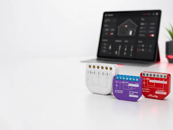 Smarte Schaltmodule vor einem Smarthome-Dashboard